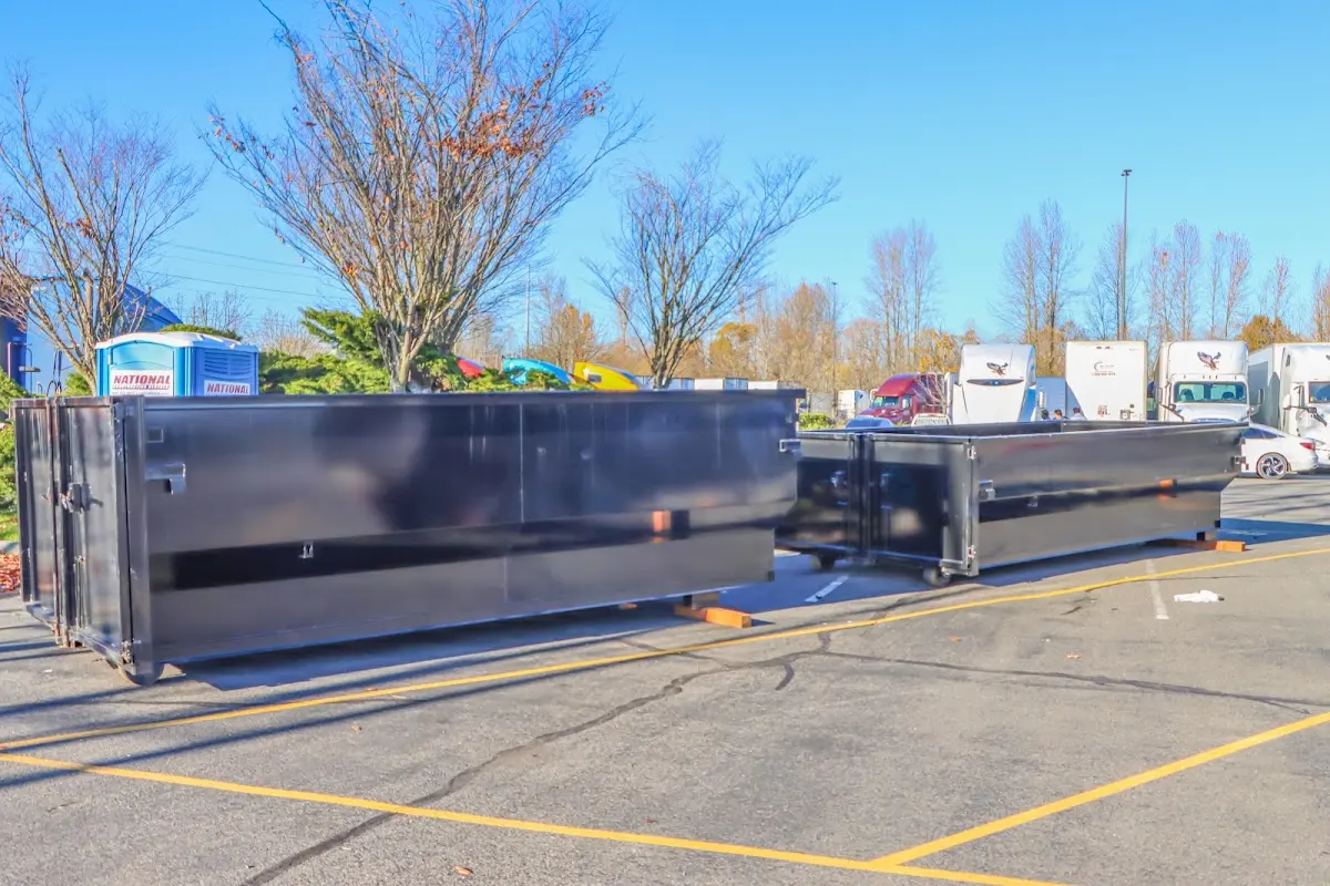 Professional dumpster rental service with roll-off container on residential driveway in Summit Park
